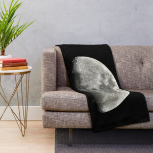 Blanked draped over couch with an image of the Moon